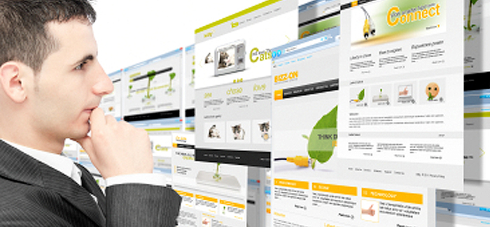 Business man looking at multiple responsive website screens